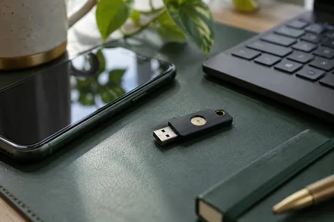 AI illustration: Physical security key beside a phone and keyboard